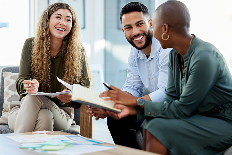 Coworkers discussing client projects in a marketing agency