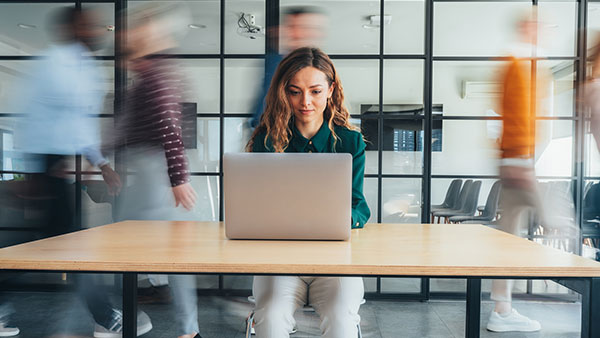 Content team member writing copy at her desk
