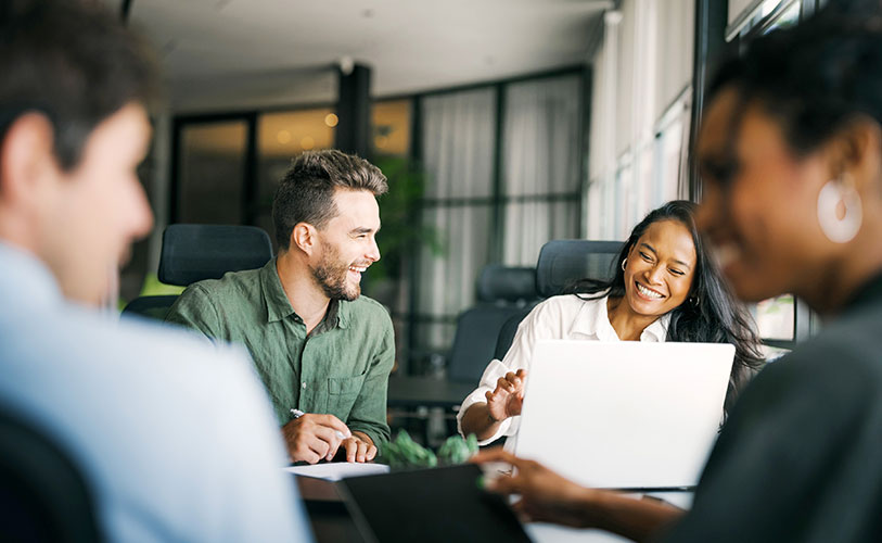 Office worker sharing a laugh during a collaboration