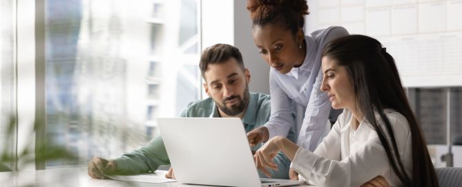 Team collaboration around a laptop