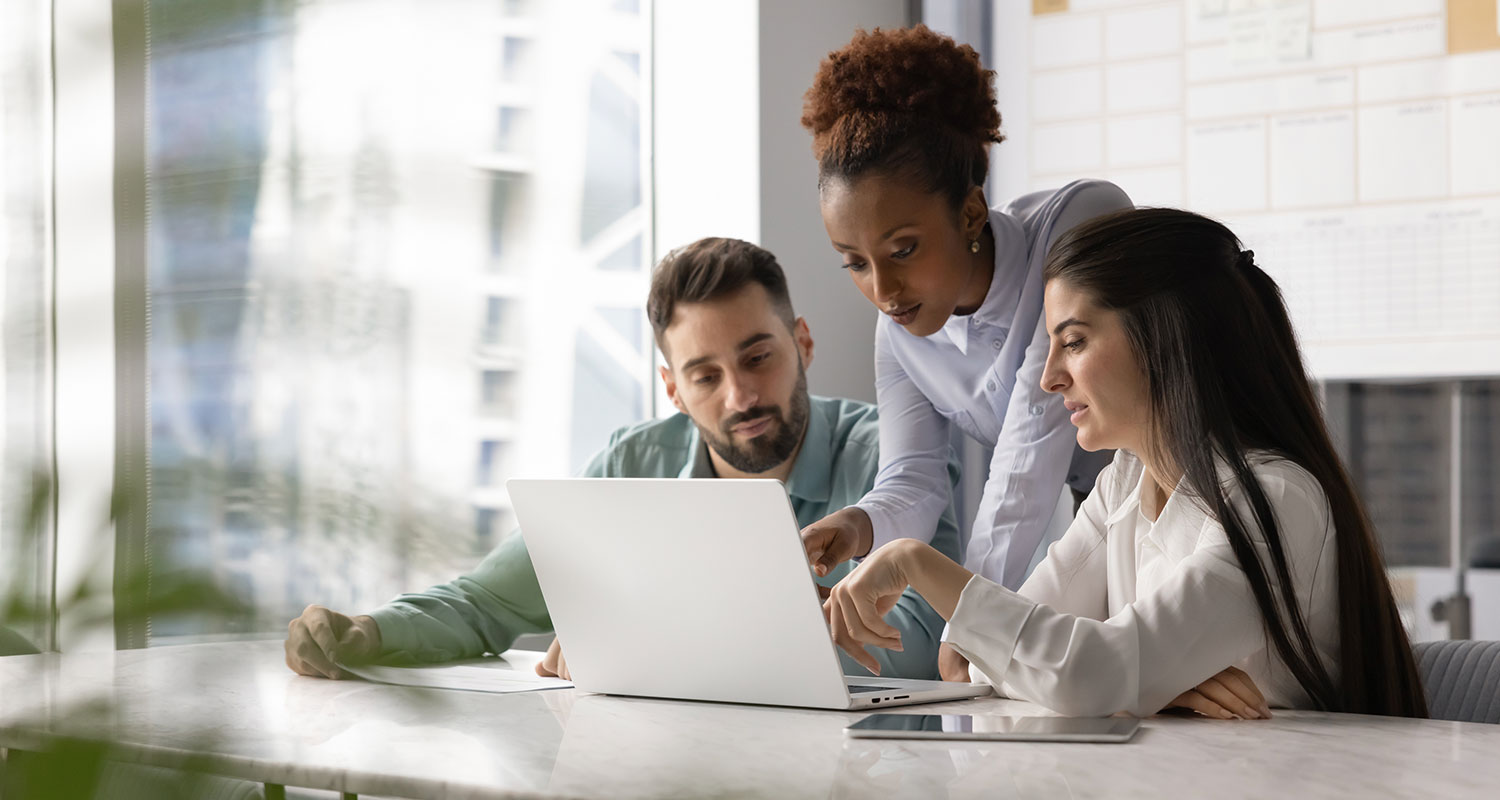 Team collaboration around a laptop