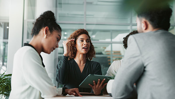 Team collaboration being led by woman with tablet