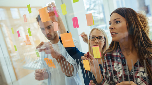 Team brainstorming and collaborating with stickies